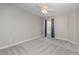 Comfortable bedroom with a window, carpet, and ceiling fan at 203 Anniston Ct, Cary, NC 27519