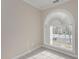 Bedroom with carpet, large arched window and view at 203 Anniston Ct, Cary, NC 27519