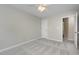 Well-lit bedroom featuring carpeted floors and a ceiling fan at 203 Anniston Ct, Cary, NC 27519