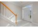 Bright entryway with tiled floor and wooden staircase at 203 Anniston Ct, Cary, NC 27519
