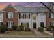 Two-story brick and siding townhouse with a charming front porch at 203 Anniston Ct, Cary, NC 27519