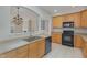 Modern kitchen with light wood cabinets, stainless steel appliances, and tile floor at 203 Anniston Ct, Cary, NC 27519