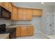 Kitchen features light wood cabinets and black appliances at 203 Anniston Ct, Cary, NC 27519