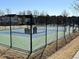 Exterior tennis court with fencing in a well-maintained community, perfect for sports and activities at 203 Anniston Ct, Cary, NC 27519