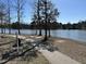 Exterior view of the community walking path near the lake with mature trees, perfect for outdoor activities at 203 Anniston Ct, Cary, NC 27519