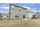View of the backyard with a sliding glass door and patio at 245 E Webber Ln, Clayton, NC 27527