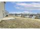 View of the large backyard, showcasing a concrete patio and the surrounding neighborhood at 245 E Webber Ln, Clayton, NC 27527