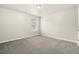 Carpeted bedroom with a window providing natural light at 245 E Webber Ln, Clayton, NC 27527