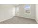 Comfortable bedroom with natural light from two windows at 245 E Webber Ln, Clayton, NC 27527