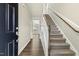 Inviting entryway with hardwood floors and carpeted staircase at 245 E Webber Ln, Clayton, NC 27527
