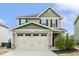 Charming two-story home with a two-car garage and manicured landscaping at 245 E Webber Ln, Clayton, NC 27527