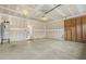 Spacious garage featuring concrete flooring, a hot water heater, and unfinished drywall at 245 E Webber Ln, Clayton, NC 27527