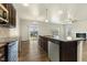 Kitchen features stainless steel appliances, granite countertops and dark cabinets, plus views to the adjacent living room at 245 E Webber Ln, Clayton, NC 27527