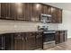 Kitchen features stainless steel appliances, granite countertops and dark cabinets at 245 E Webber Ln, Clayton, NC 27527