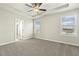 This main bedroom features a ceiling fan and two windows that provide plenty of natural light at 245 E Webber Ln, Clayton, NC 27527