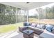 Relaxing screened porch with comfortable seating and wooded views at 2919 Huxley Way, Apex, NC 27502