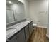 Double vanity bathroom with granite countertops and a shower at 395 Magnolia Run Way, Benson, NC 27504