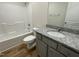 Bathroom with granite vanity, a tub shower combo, and gray cabinets at 395 Magnolia Run Way, Benson, NC 27504
