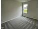 Simple bedroom with gray carpeting and a window offering natural light at 395 Magnolia Run Way, Benson, NC 27504