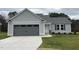 New single-story home with gray siding, a two-car garage, and a well-manicured lawn at 395 Magnolia Run Way, Benson, NC 27504