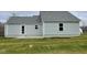 Gray vinyl-sided house with a small patio and grassy yard at 395 Magnolia Run Way, Benson, NC 27504