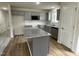 Modern kitchen with gray cabinets, granite countertops, and an island at 395 Magnolia Run Way, Benson, NC 27504