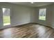 Bright spare bedroom with hardwood floors and a view of the backyard at 395 Magnolia Run Way, Benson, NC 27504