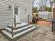 Back patio access with brick flooring and stairs at 4532 Malvern Rd, Durham, NC 27707