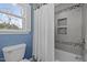 Bathroom with shower/tub combo and window at 4532 Malvern Rd, Durham, NC 27707