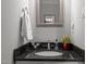 Small bathroom with black granite countertop and a framed mirror at 4532 Malvern Rd, Durham, NC 27707