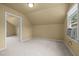 Bright bedroom with carpet, window, and door to another room at 4532 Malvern Rd, Durham, NC 27707