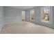 Simple bedroom with neutral colored carpet and window shutters at 4532 Malvern Rd, Durham, NC 27707