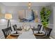 Formal dining room with a wooden table, place settings, and artwork at 4532 Malvern Rd, Durham, NC 27707