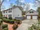Gray sided home with red door, two car garage, and landscaping at 4532 Malvern Rd, Durham, NC 27707