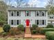 Two story house with gray siding, red door, and brick walkway at 4532 Malvern Rd, Durham, NC 27707