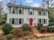 Two story house with gray siding, red door, and brick walkway at 4532 Malvern Rd, Durham, NC 27707