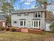 Two-story house with gray siding, brick patio, and landscaping at 4532 Malvern Rd, Durham, NC 27707