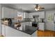 Modern kitchen with white cabinets, stainless steel appliances, and large island at 4532 Malvern Rd, Durham, NC 27707