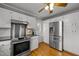 Kitchen boasts stainless steel appliances and white cabinetry at 4532 Malvern Rd, Durham, NC 27707