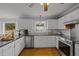 Modern kitchen with white cabinets, stainless steel appliances, and large island at 4532 Malvern Rd, Durham, NC 27707