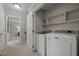 Convenient laundry room with washer, dryer, and shelving at 4532 Malvern Rd, Durham, NC 27707