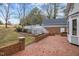 Brick patio with deck and access to backyard at 4532 Malvern Rd, Durham, NC 27707