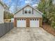 Two-car brick garage with dormer windows and long driveway at 4532 Malvern Rd, Durham, NC 27707