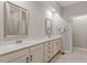 Double vanity bathroom with a large mirror and neutral colors at 505 Great Eno Path, Hillsborough, NC 27278