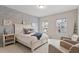 Bright bedroom with white furniture and patterned accent wall at 505 Great Eno Path, Hillsborough, NC 27278