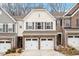 Two-story townhome with beige vinyl siding, two-car garage, and landscaping at 505 Great Eno Path, Hillsborough, NC 27278