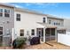 Home's back exterior showcases a screened porch and patio at 505 Great Eno Path, Hillsborough, NC 27278