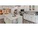 Island kitchen with white cabinets and a decorative cutting board wall at 505 Great Eno Path, Hillsborough, NC 27278