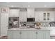 Modern kitchen with white cabinets, stainless steel appliances, and a large island at 505 Great Eno Path, Hillsborough, NC 27278