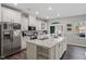 Modern kitchen with white cabinets, island, and stainless steel appliances at 505 Great Eno Path, Hillsborough, NC 27278